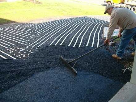 Installing heat cable for asphalt heated driveway.