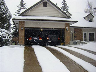 Heated tire tracks in a radiant heated driveway.