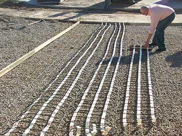 Heat cable in mats being installed for a concrete heated driveway.