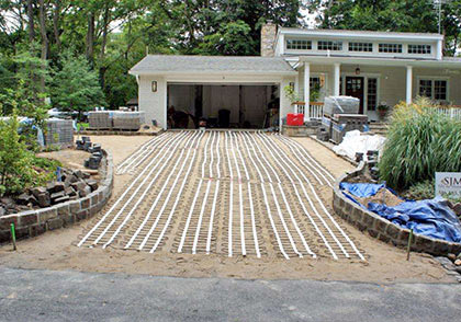 Snow melting mats being installed to heat a brick paver driveway.