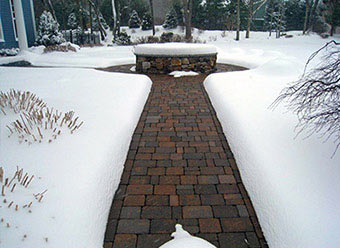 Heated sidewalk with brick pavers.